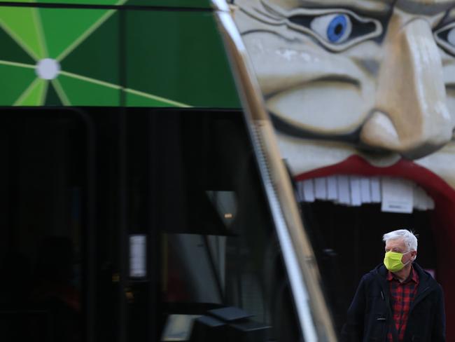 Victorians are in lockdown but travel is permitted for four reasons. Here, a man boards a tram in St Kilda. Picture: Getty Images