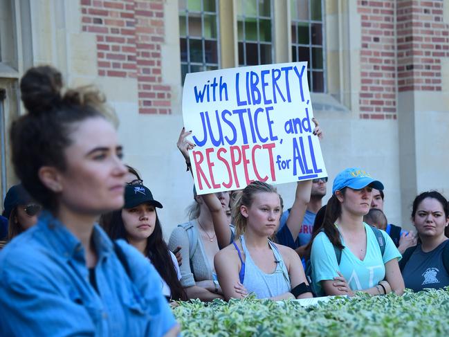 University of California Los Angeles students hold signs and listen to speeches before marching through campus on November 10, 2016 in Los Angeles, California, during a "Love Trumps Hate" rally in reaction to President-elect Donald Trump's victory in the presidential elections.  / AFP PHOTO / Frederic J. BROWN