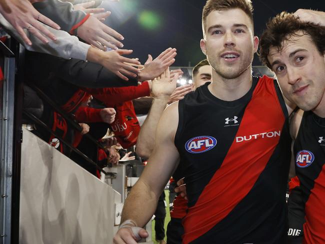 NCA . MELBOURNE, AUSTRALIAÃ July 5 , 2024.  AFL  Round 17. Collingwood vs Essendon at the MCG.   Zach Merrett , captain of the Bombers  and Andrew McGrath , who played his 150th game led the team off the MCG    . Pic: Michael Klein