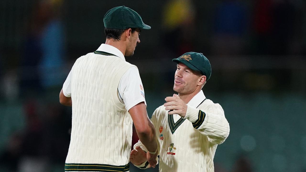Mitchell Starc and David Warner of Australia embrace at the end of the days play