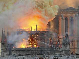 Flames and smoke rise from the blaze after the spire toppled over on Notre Dame cathedral in Paris, Monday, April 15, 2019. Picture: Thierry Mallet