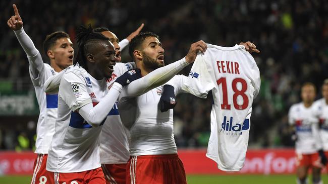 Lyon's French midfielder Nabil Fekir shows his shirt after celebrating.