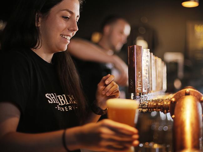 Genevieve Henderson serves an Afternoon Delight Summer Ale, brewed at the Shambles Brewery, Hobart.Picture: MATHEW FARRELL