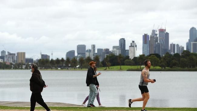 People exercising at Albert Park Lake in Melbourne during day one of a five-day lockdown. Picture: Getty