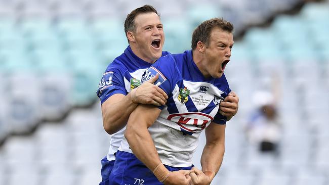 Josh Morris of the Bulldogs (right) celebrates with brother Brett (left) after scoring a try during the Round 3 NRL match between the Canterbury-Bankstown Bulldogs and the Penrith Panthers at ANZ Stadium in Sydney, Friday, March 23, 2018. (AAP Image/Dan Himbrechts) NO ARCHIVING, EDITORIAL USE ONLY