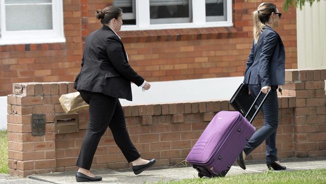 Detectives leave the house of Ho Ledinh after investigations. Picture: Jeremy Piper