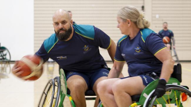 Invictus Games 2025 Team Australia competitor Sue Osborn attempts to tackle Torben Louwen-Skovdam during a wheelchair basketball training session held at the Australian Institute of Sport, in Canberra.