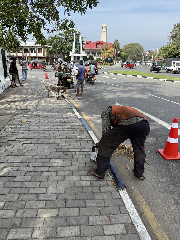 Workers do some cosmetic work to prepare for Australia’s arrival. Picture: MB Miller