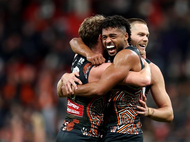 Connor Idun, Lachie Whitfield and Harry Himmelberg of the Giants celebrate at full time in their win over Carlton. Picture: Brendon Thorne/AFL Photos/via Getty Images.