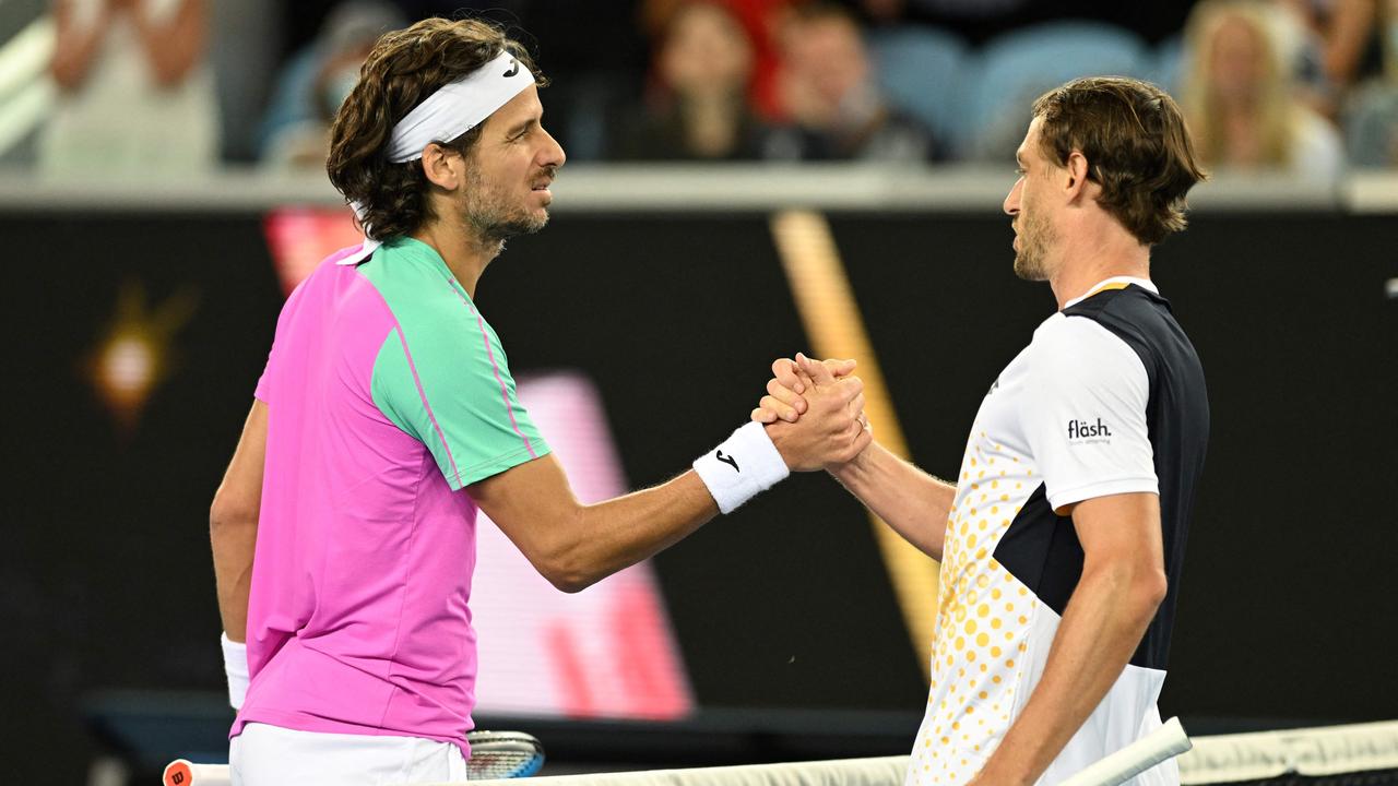 Respect between Feliciano Lopez and John Millman. Photo by MICHAEL ERREY / AFP