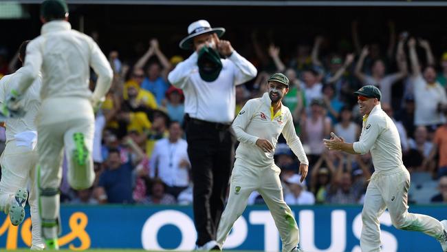 Australia's Nathan Lyon, second from right, celebrates the run out of England batsman James Vince. Picture: AFP