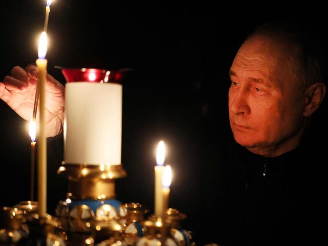 Vladimir Putin lights a candle during his visit to a church of the Novo-Ogaryovo state residence outside Moscow, during a national day of mourning following the attack in the Crocus City Hall. Picture: AFP