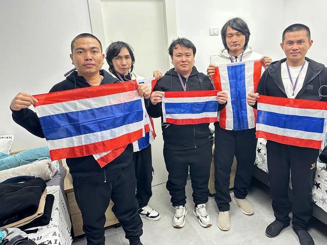 This handout photo taken by the Royal Thai Embassy in Tel Aviv on January 30, 2025 and released by Thailand's Ministry of Foreign Affairs on January 30 shows released Thai hostages (from L to R) Surasak Rumnao, Sathian Suwannakham, Bannawat Saethao, Watchara Sriaoun and Pongsak Thaenna posing with Thai national flags in Tel Aviv, after their release by Hamas as part of the Israel-Hamas exchange under a ceasefire deal. The five Thai farm labourers, held hostage for nearly 16 months in the Gaza Strip, were released by Hamas on January 30 during a truce between Israel and the Palestinian militant group. (Photo by Handout / various sources / AFP) / RESTRICTED TO EDITORIAL USE - MANDATORY CREDIT "AFP PHOTO / Royal Thai Embassy in Tel Aviv via Thailand's Ministry of Foreign Affairs" - NO MARKETING NO ADVERTISING CAMPAIGNS - DISTRIBUTED AS A SERVICE TO CLIENTS