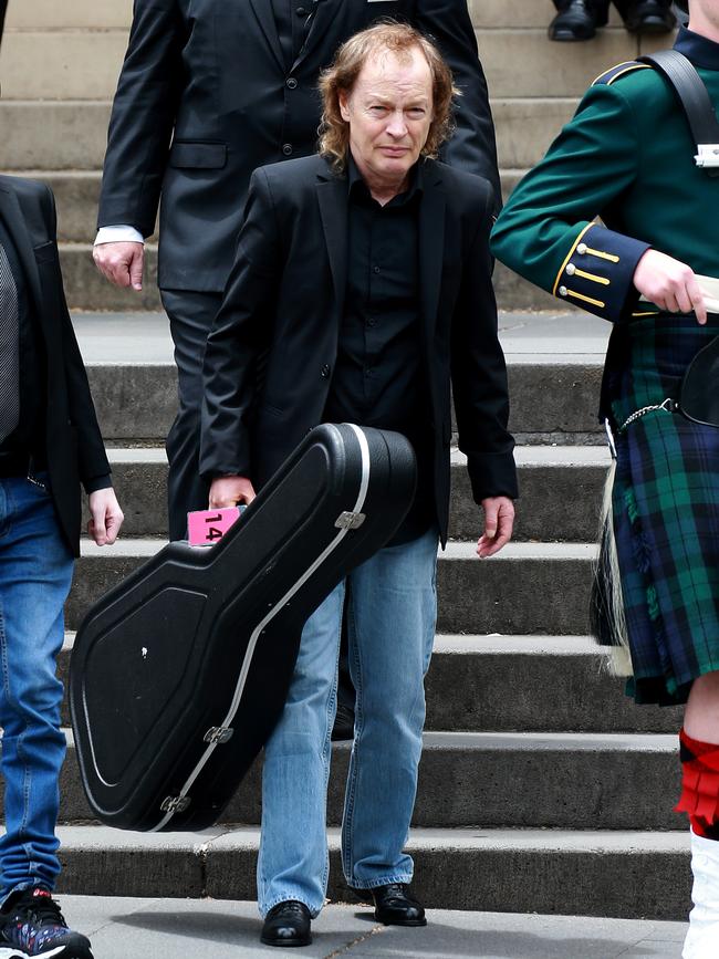 Angus Young carries Malcolm’s guitar, The Beast, at his brother’s funeral in 2017. Picture: Toby Zerna