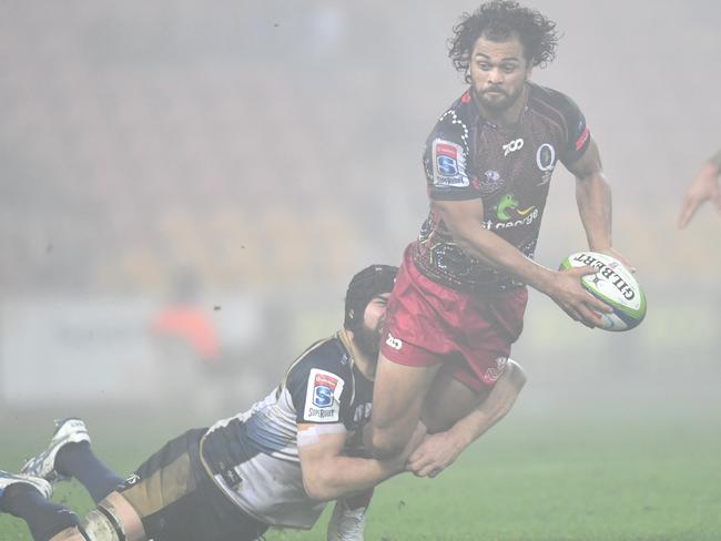 Karmichael Hunt is cut down in the fog by a Brumbies defender.