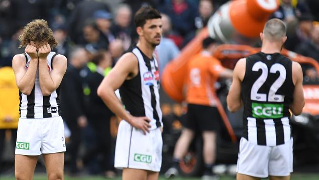 (from left) Chris Mayne, Scott Pendlebury and Steele Sidebottom after Collingwood’s loss.