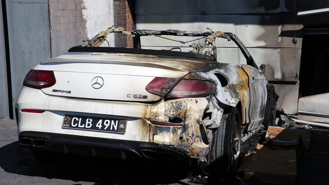 A Mercedes Benz was ruined when a house was firebombed. Photo by: NCA Newswire/ Gaye Gerard