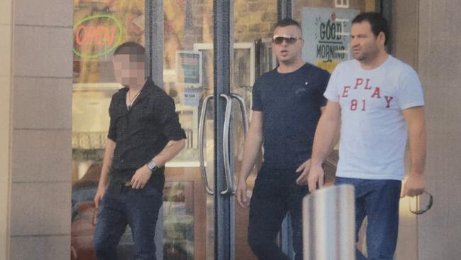 The courier (left), Ibrahim Yavuz (centre) and Alfred Kola (right) leave Flight Centre at Mawson Lakes in May 2014 after purchasing the courier flights to Panama. Picture: Courts SA.