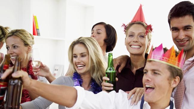 Close-up of co-workers celebrating with beers at a office Christmas party. Generic image. Thinkstock.