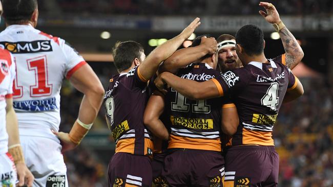 Brisbane Broncos players celebrate a try during the round 24 NRL game between the Brisbane Broncos and the St George Illawarra Dragons at Suncorp Stadium in Brisbane, Friday, August 18, 2017. (AAP Image/Dan Peled) NO ARCHIVING, EDITORIAL USE ONLY