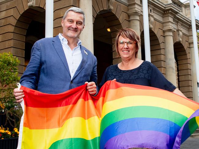 Equality advocate Rodney Croome AM with Tas Pride spokesperson Sielito at Hobart Town Hall with a flag to signal Tas Pride.Picture: Linda Higginson