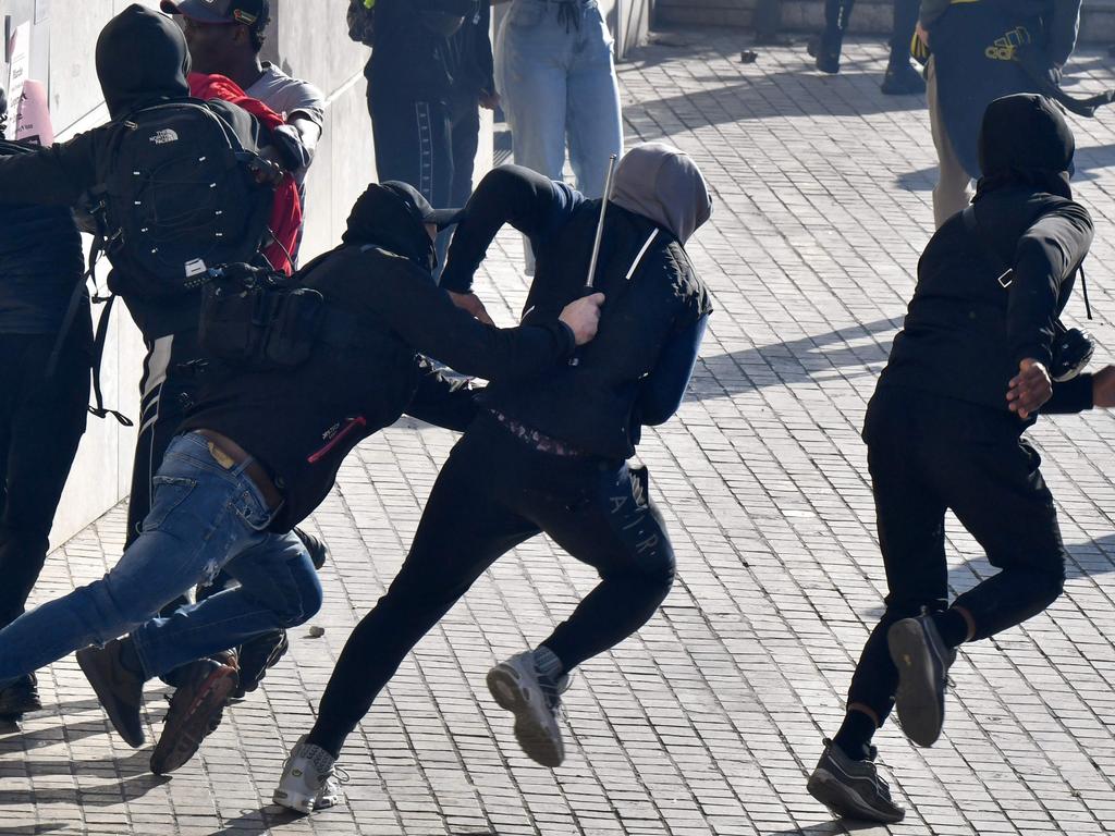 Police officers chase demonstrators on December 6 in Marseilles. Picture: Gerard Julien/AFP