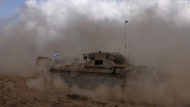 An Israeli army tank drives in an area near Israel's southern border with the Gaza Strip on October 6. The Israeli military said its forces surrounded the Jabaliya area of northern Gaza in response to indications Hamas was rebuilding despite nearly a year of strikes and fighting. Picture: AFP