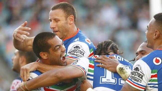 Warriors players celebrate after scoring a try.