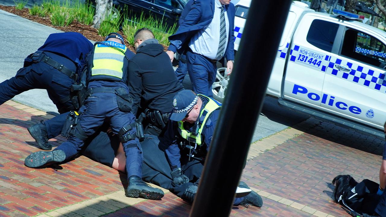 Police are seen during a scuffle with people claiming know the slain man in Keilor Village. Picture: NCA NewsWire / Luis Enrique Ascui