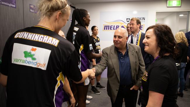 Victorian Treasurer Tim Pallas with members of the Melbourne Boomers at the State Basketball Centre.