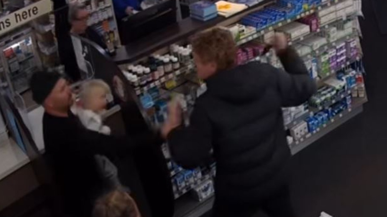 Travis Johnston (right) confronts Marty Cooper and son, Forrest, with a knife in a Torquay chemist.