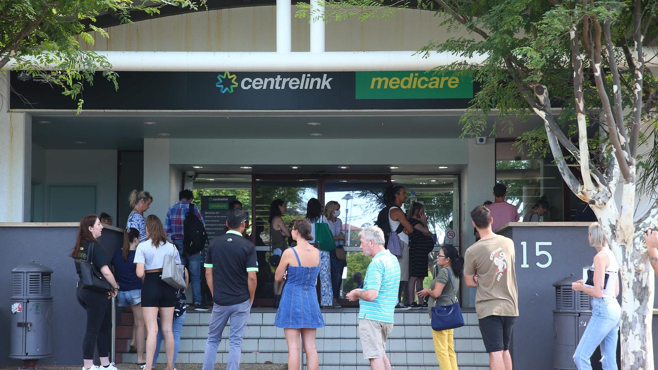 Lines of people wait at Southport Centrelink. Picture: Adam Head.