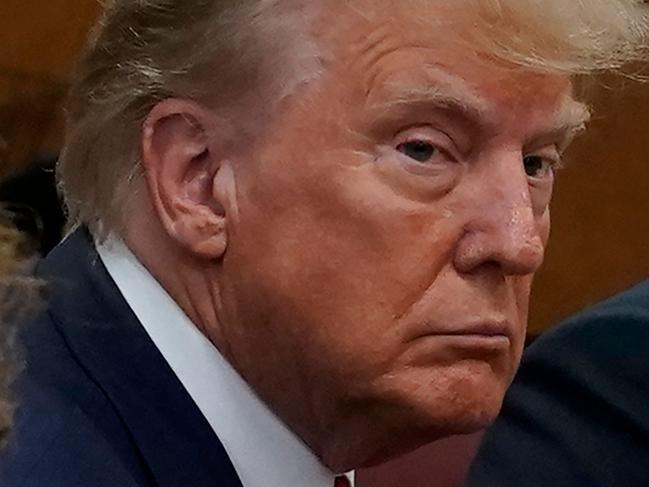 Former US president Donald Trump (R) appears in court at the Manhattan Criminal Court in New York on April 4, 2023. - Former US president Donald Trump arrived for a historic court appearance in New York on Tuesday, facing criminal charges that threaten to upend the 2024 White House race. (Photo by Timothy A. CLARY / POOL / AFP)