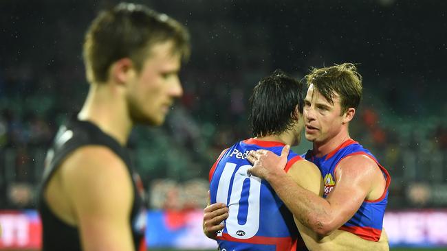 The Bulldogs celebrate as the Bombers ponder what could have been. Photo by Steve Bell/AFL Photos/via Getty Images