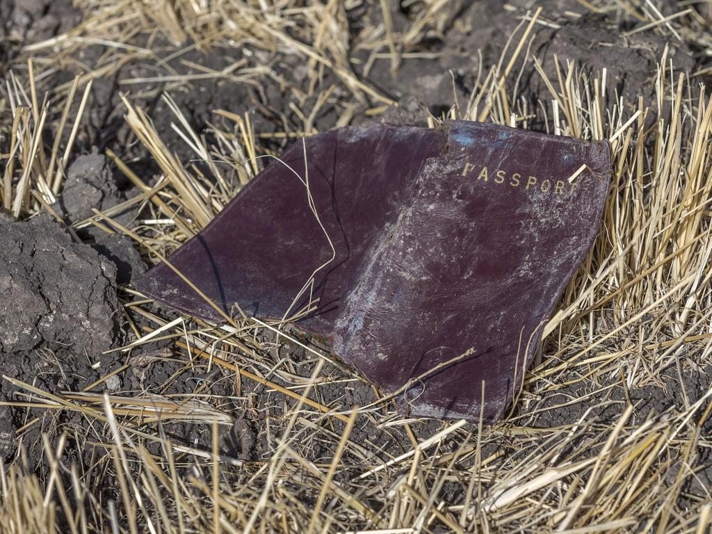 A passenger passport lies on the ground at the scene of an Ethiopian Airlines flight crash. Share prices of Boeing Co. took a massive dive when markets opened on Monday. Picture: AP Photo/Mulugeta Ayene