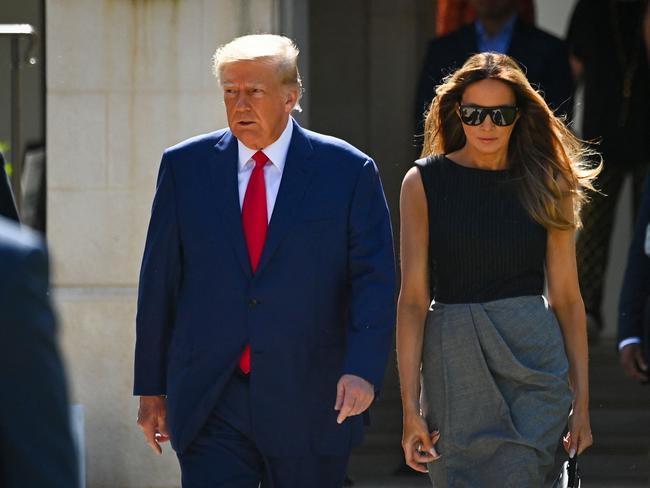 TOPSHOT - Former US President Donald Trump and his wife,  Melania Trump, leave a polling station after voting in the US midterm elections in Palm Beach, Florida, on November 8, 2022. (Photo by Eva Marie UZCATEGUI / AFP)