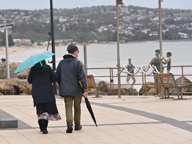 A couple out for a stroll between Glenelg and Brighton after 3pm on Thursday. Picture: Keryn Stevens.