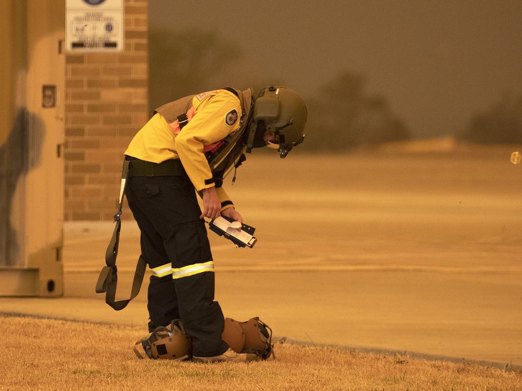 Rural Fire Service employee Dwyane Graham prepares for another sortie on an 808 Squadron MRH90 Taipan Military Support Helicopter at HMAS Albatross, Nowra. Picture: ADF