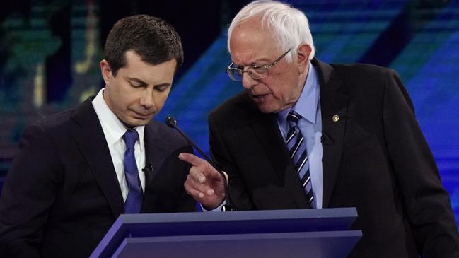 South Bend Mayor Pete Buttigie and Bernie Sanders talk during a break in the debate. Picture: AP.