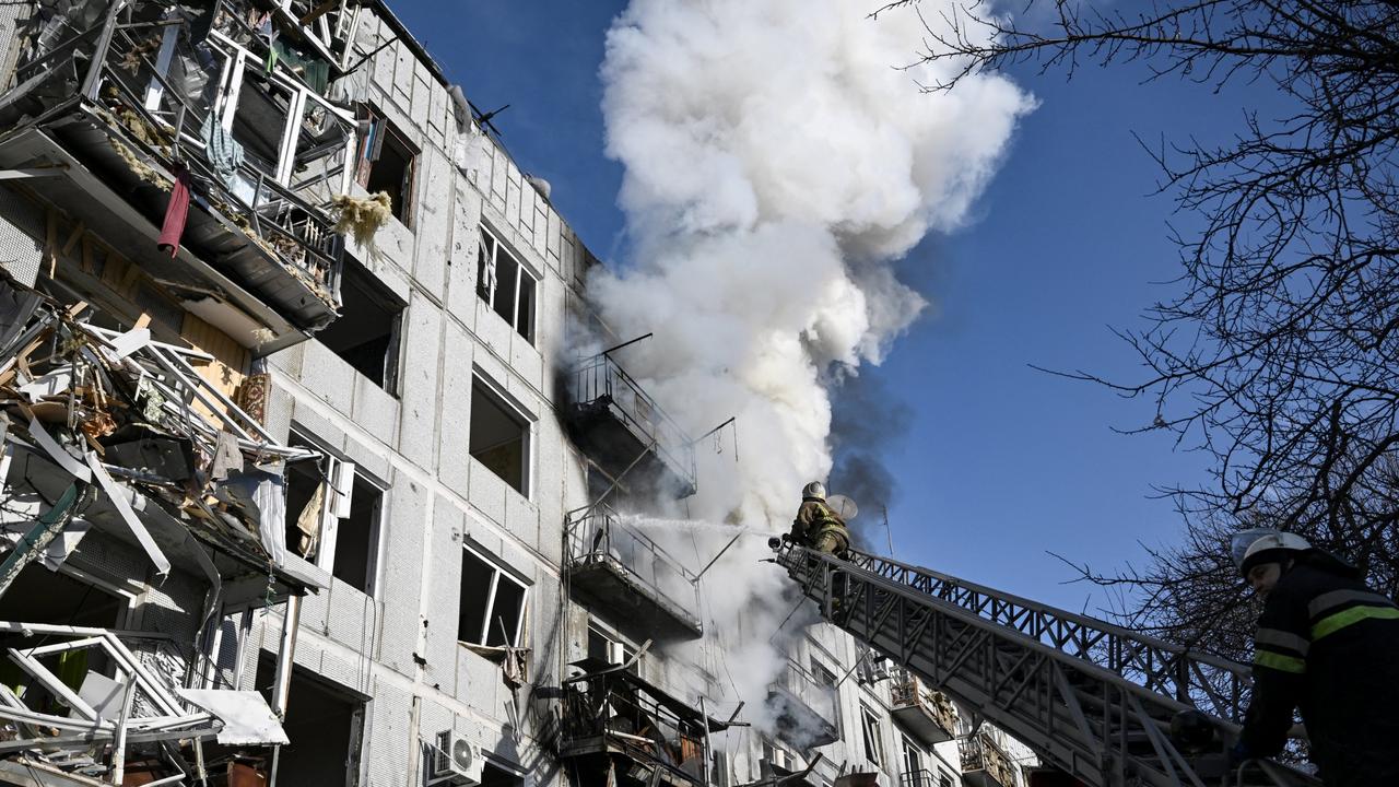 Firefighters work on a fire on a building after bombings on the eastern Ukraine town of Chuguiv. Picture: Aris Messinis / AFP