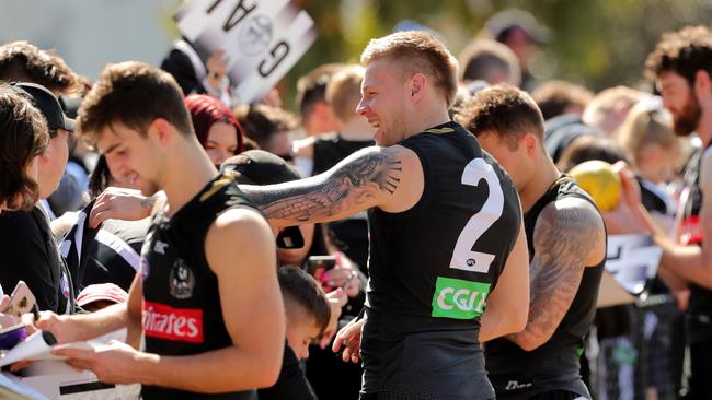 Collingwood star Jordan De Goey signs autographs after today’s open training session. Picture: Stuart McEvoy