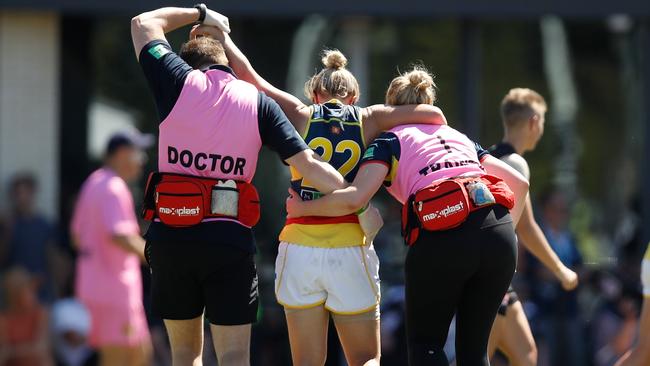 Courtney Cramey is helped off the field.