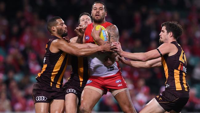 Lance Franklin is gang tackled by Josh Gibson, James Frawley and Ben Stratton. Picture: AAP