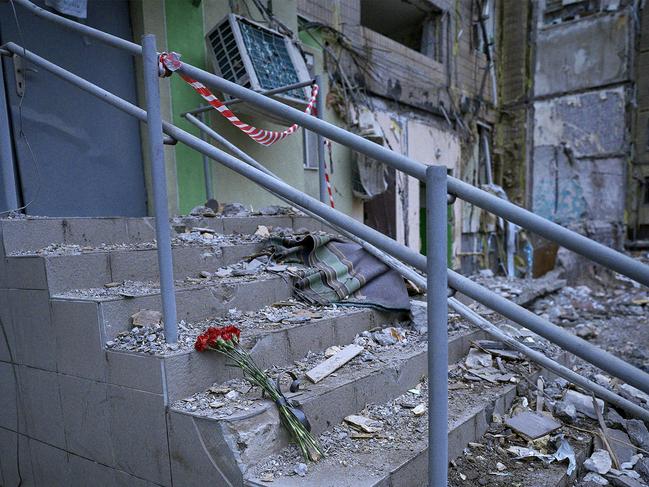 Red carnations placed on the steps of a residential building in Dnipro, destroyed as a result of a missile strike. Picture: AFP