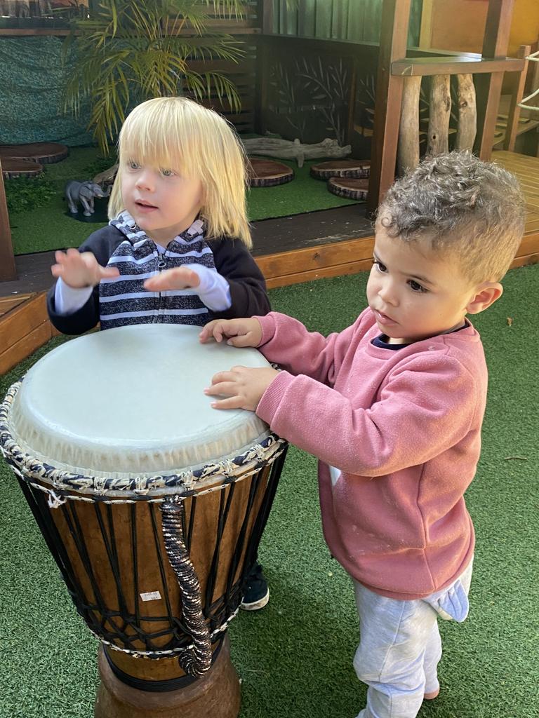 Children enjoying the bongo drums.