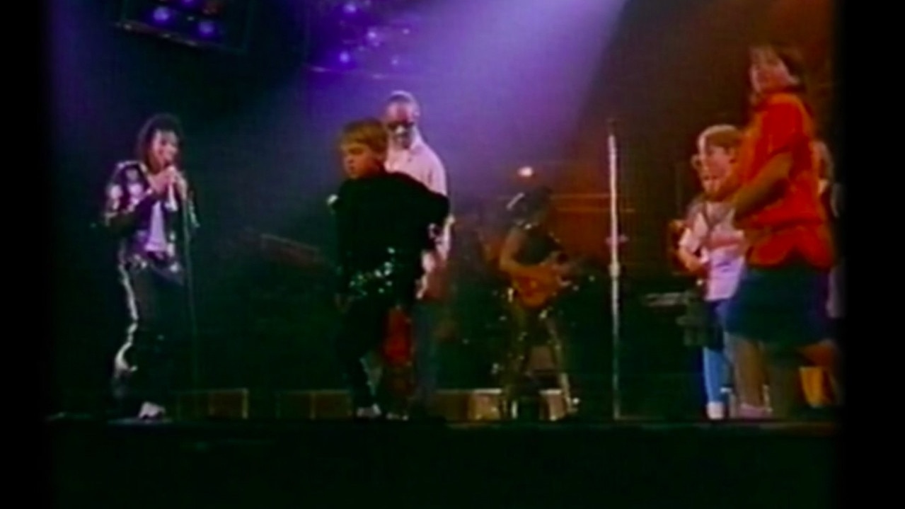 Robson (centre) dances on stage with Jackson during his Australian tour. 