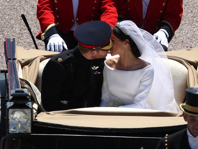 The couple broke with tradition once again stealing a second kiss on the carriage ride after the ceremony. Picture: WPA Pool/MEGA