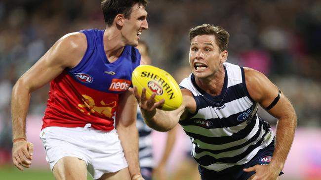 Lions big man Oscar McInerney, left, battled through the pain of a rolled ankle for three quarters against the Cats. Picture: Michael Klein