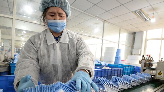 A worker in China packages face masks at a factory in Handan. Picture: AFP