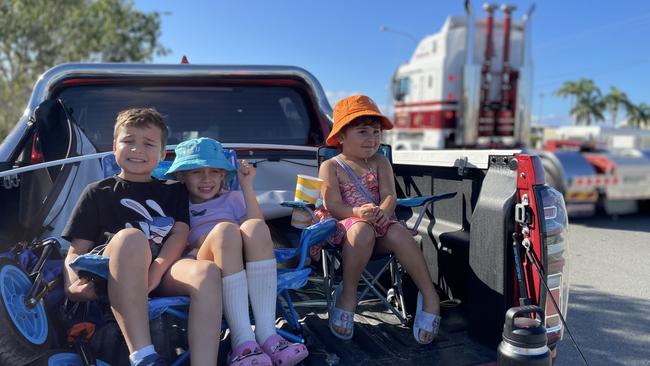 Samuel Kyle, 8, Alliana Booth, 7, and Chloe Kyle, 4, wait in the back of a utility vehicle to watch the convoy go past in Ingham Road.